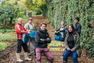 Fifth generation apple grower Greg MacNeice of Mac Ivors Cider Co with journalist Eleanor McGillie with Polish apple pickers in MacNeice's orchards in Co Armagh. MGMPR_01